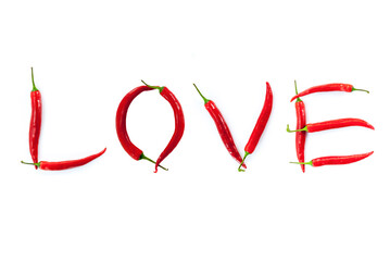 Love word written with red chili peppers on white background concept photo