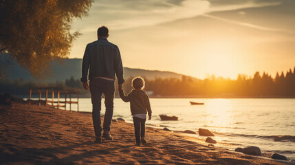 parent and child walking on the beach at sunset - obrazy, fototapety, plakaty