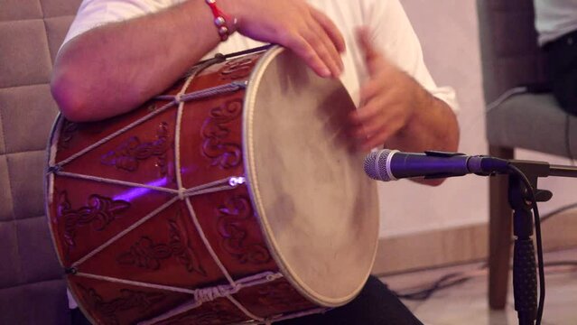 Nizhny Novgorod, Russia, Kazanskoye shosse 29, 08.31.2023. The musician plays the Armenian drum. Dhol, Armenian percussion instrument. High