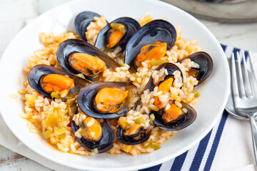 Close up of  rice with mussels cooked with some vegetables