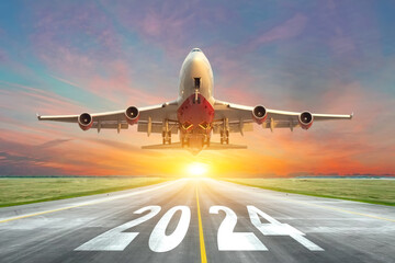 Inscription on the runway 2024 surface of the airport road with take off big airplane enjoy travel sunset sunrise dawn. Concept of travel in the new year, holidays. - obrazy, fototapety, plakaty