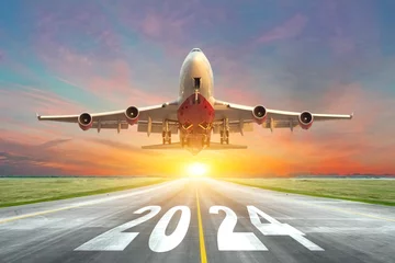 Cercles muraux Avion Inscription on the runway 2024 surface of the airport road with take off big airplane enjoy travel sunset sunrise dawn. Concept of travel in the new year, holidays.