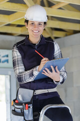 Fototapeta premium happy female builder with a clipboard