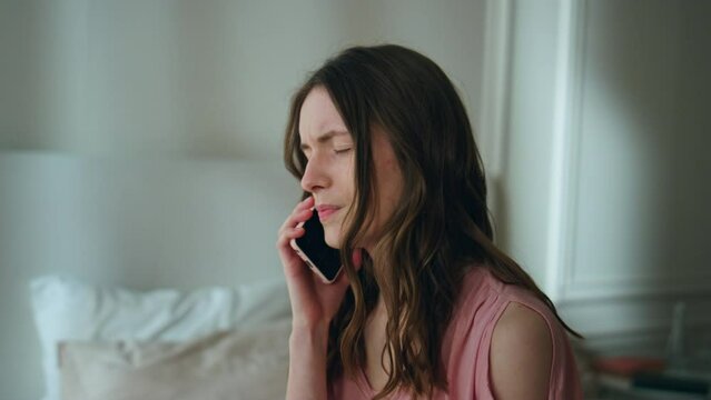 Upset woman answering mobile phone at night closeup. Unhappy sad girl crying