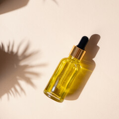 Fototapeta premium Natural oil in a glass jar with a pipette on a beige background. Hair and Skin Care, for Face and Body