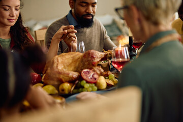 Close up of couple saying grace during family meal on Thanksgiving.