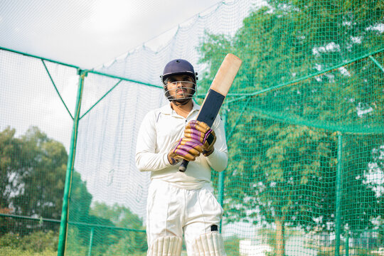 cricket player is ready to practice batting in the nets during his practice time
