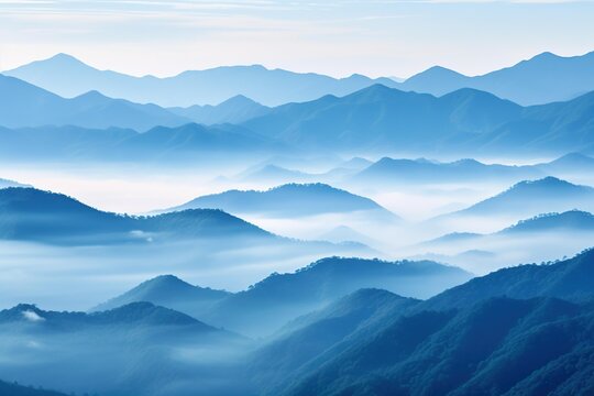 Layered mountain ranges softened by early morning fog