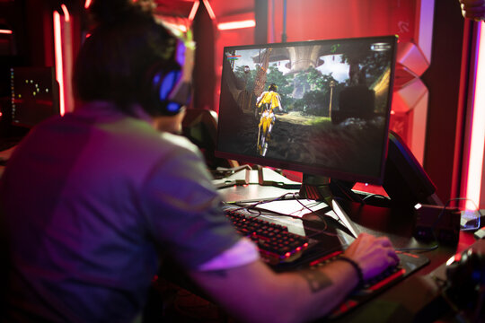 Back view of a professional gamer participating in a esport tournament