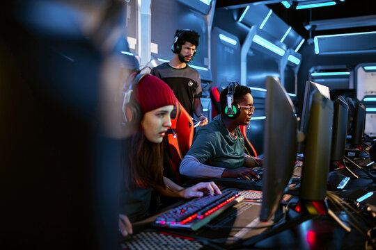 Professional female esport team participating in a tournament at the gaming club