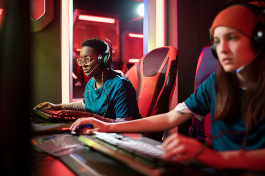 Professional female esport team participating in a tournament at the gaming club
