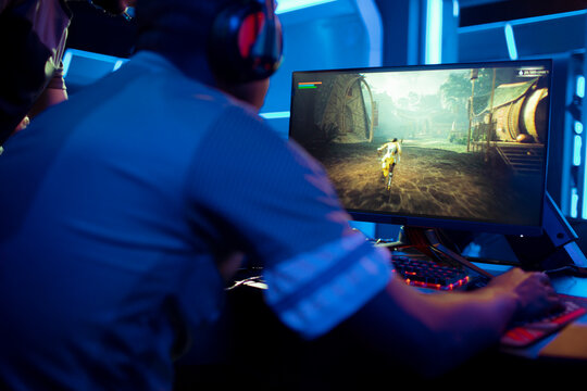 Back view of a professional gamer participating in a esport tournament