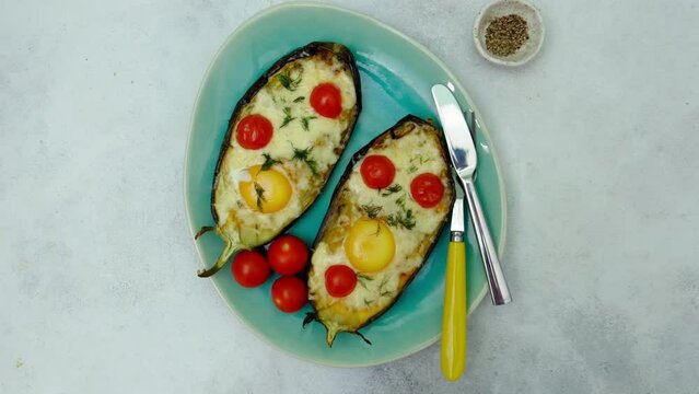 close up of backed eggplant with cheese and tomatoes, top view.
