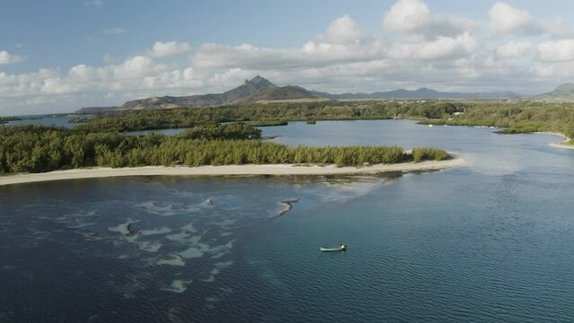 Aerial view of a fishing boat along the coastline of Ilot Mangenie island, Ilot Lievres, Flacq, Mauritius.