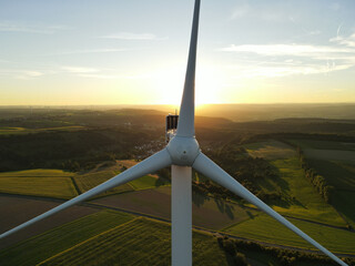 Wind turbine on a sunny evening in the landscape 