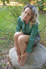 Outdoor shooting, blonde woman with autumn clothes. Blue eyes