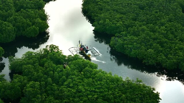 Aerial view of people on a canoe sailing along the Maasin River, Siargao, Philippines.