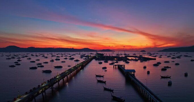 .aerial view scenery red cloud in sky of twilight over Chalong pier..beautiful sunrise landscape amazing light of nature sky over horizon..colorful sky sunrise background.