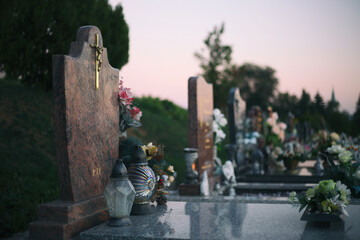 Close up of Votive candles lantern on the grave in Slovak Catholic cemetery during day. Autumn scene. All Hallows eve. Memorial to the deceased. Solemnity of All Saints. 1st November, All Saints' Day