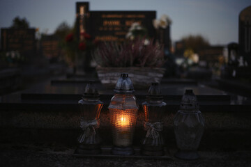 Votive candles lantern burning on the graves in Slovak cemetery at night time. All Saints' Day. Solemnity of All Saints. Hallows eve. 1st November. Feast of Saints. Hallowmas. Souls' Day in Slovakia