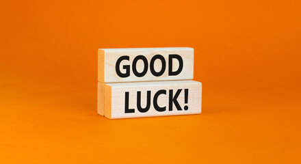 Good luck symbol. Concept words Good luck on beautiful wooden block. Beautiful orange table orange background. Business, motivational good luck concept. Copy space.