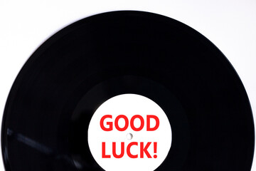 Good luck symbol. Concept words Good luck on beautiful black old retro vinyl disc. Beautiful white table white background. Business, motivational good luck concept. Copy space.