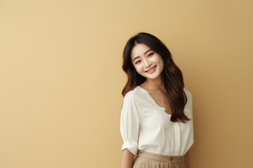 Obraz premium A woman standing in front of a neutral-colored wall
