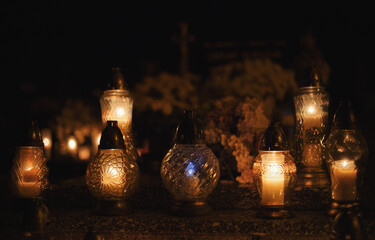 Votive candles lantern burning on the graves in Slovak cemetery at night time. All Saints' Day. Solemnity of All Saints. Hallows eve. 1st November. Feast of Saints. Hallowmas. Souls' Day in Slovakia