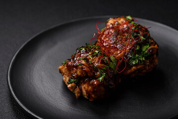 Delicious juicy fried chicken in teriyaki sauce with salt, spices, herbs and sesame seeds