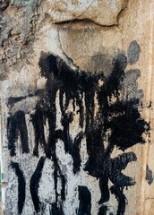Abstract paint grunge background. Drty old cement wall with black paint stains 
