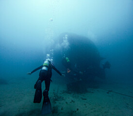 Naklejka na ściany i meble diver and sunken ship in the background