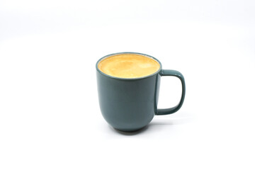 Mug of hot frothy coffee isolated on a plain white background. Copy space.