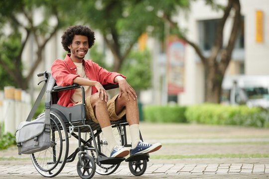 Smiling Black College Student In Wheelchair Spending Free Time On Campus