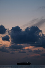 Ship at sunset, cloudy evening
