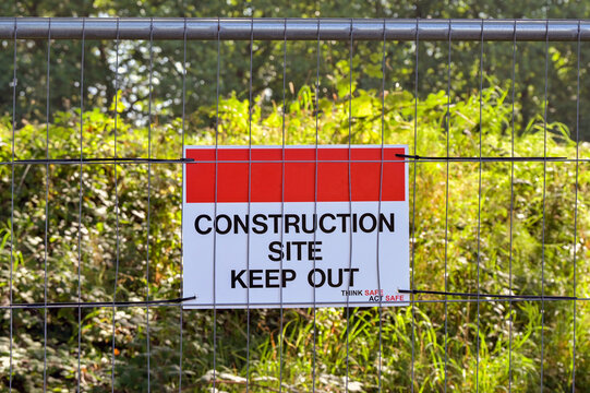 Keep out sign on the metal fence of a construction site. No people.