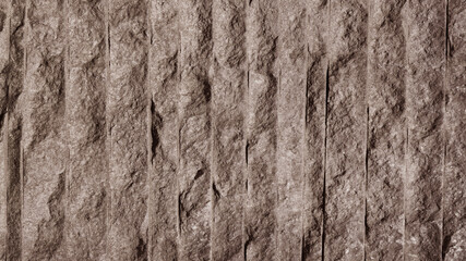 A strip of parallel stone wall cladding.