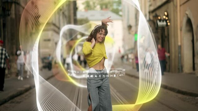 A young woman in a bright top and jeans dances on the street to music from her headphones, with impressive holographic effects, enhancing her musical experience
