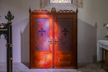 A confessional inside a church, a private space for the confession of the faithful.