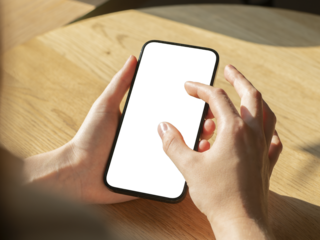 Hand holding mobile phone screen mockup, enlarging photo on blank display