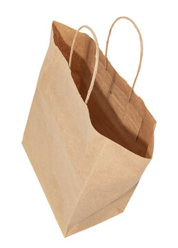 Paper shopping bag on a white background. Kraft bag with handles isolate