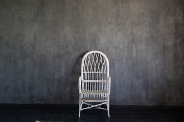 White vintage vintage armchair in dark grey room interior