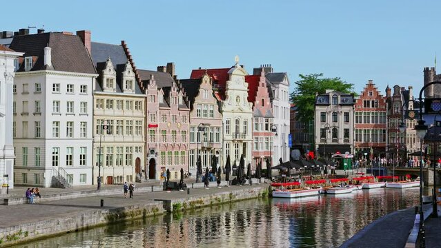 Summer streets and riverside of Ghent. Buildings along River Scheldt, Flemish Region.