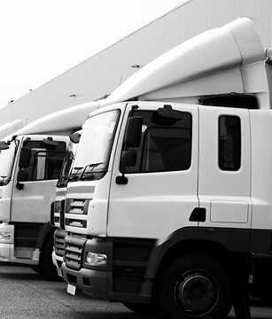 lorries parked up outside a company's car parking area no people stock photo