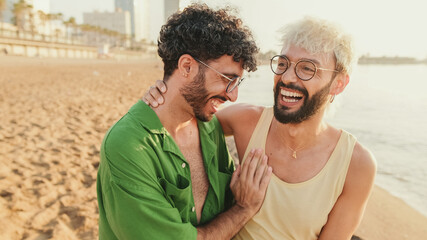 Close-up happy gay couple walking hugging on the beach