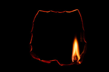 burning paper, glowing edge of paper on a black background