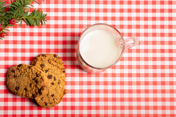 glass of milk and cookies on a checkered background