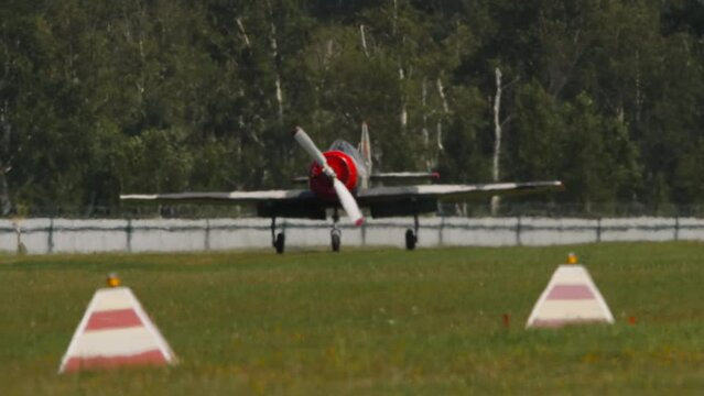Sports trainer aircraft landing. Retro plane at an airshow. Soviet plane Yakovlev