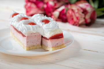 Delicious sweet cake close-up selective focus, cake with white protein cream decorated with strawberries