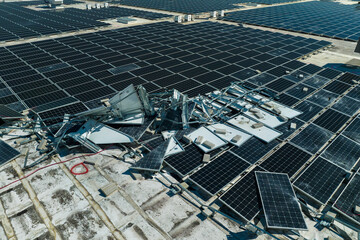 Consequences of natural disaster. Damaged by hurricane wind photovoltaic solar panels mounted on...