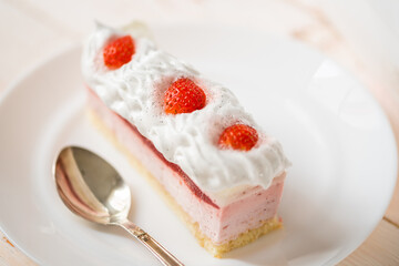 Delicious sweet cake close-up selective focus, cake with white protein cream decorated with strawberries